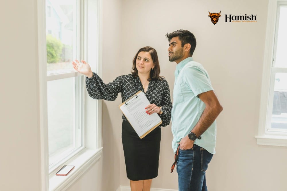 Estate agent and homeowner working together to sell property