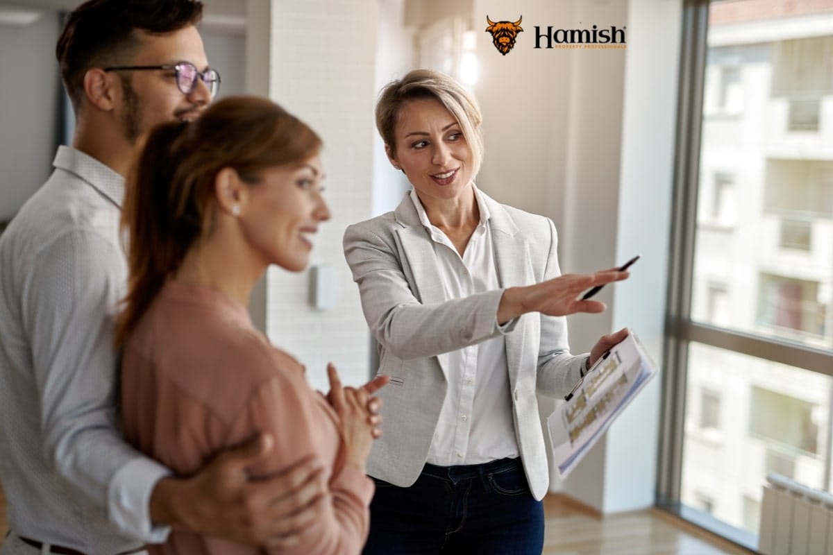 Estate agent discussing home valuation with homeowners