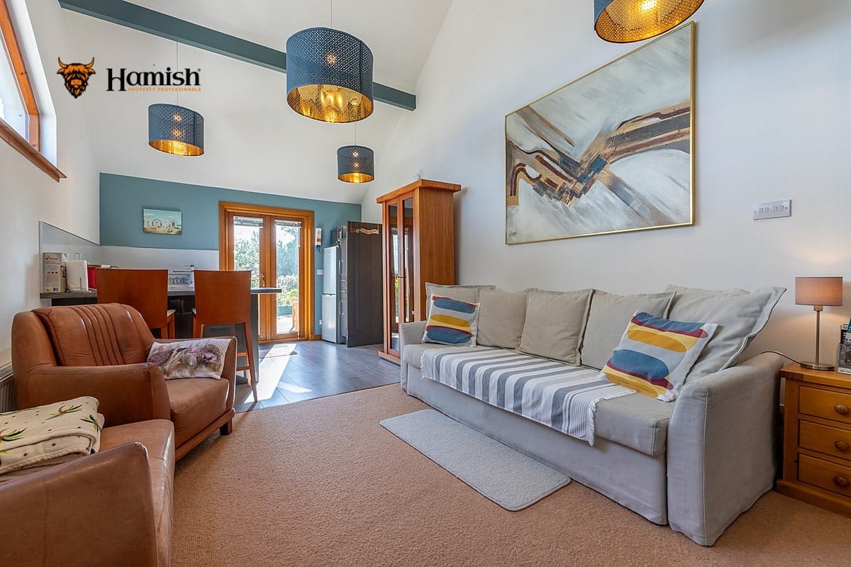 LUXURY STYLING SIMPLE HACKS TO MAKE ROOMS FEEL MORE EXPENSIVE 2 Elegant living room with cosy cushions and warm lighting